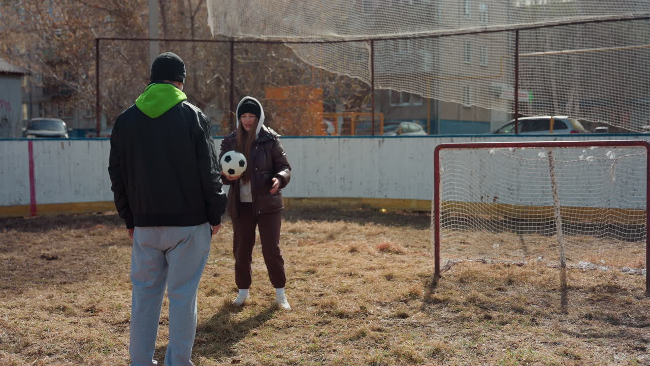 female player practicing, athletic woman focusing on scoring during training session, skilled woman athlete practicing goal shot under attentive coach supervision on dry training ground