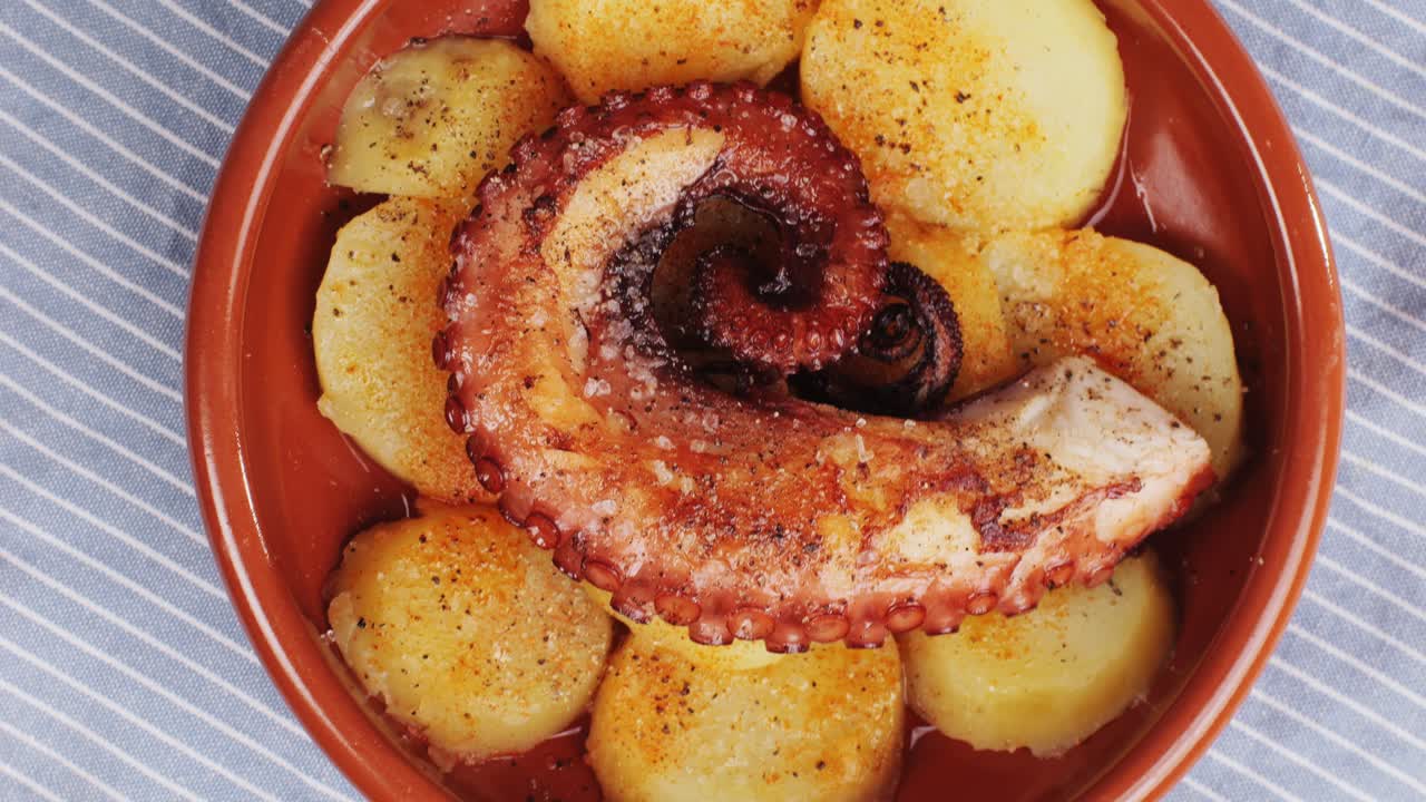 Octopus cooking, chef grill fresh octopus galician style on restaurant kitchen, healthy food, seafood cafe in spain, traditional asian japanese spanish and mediterranean dish.