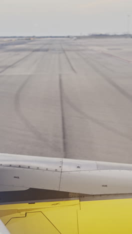 view from a plane window as it lands at airport shot in vertical