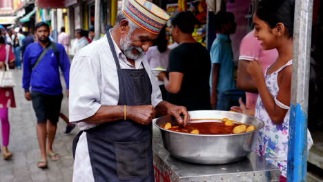 street food vendor and child customer in indian market