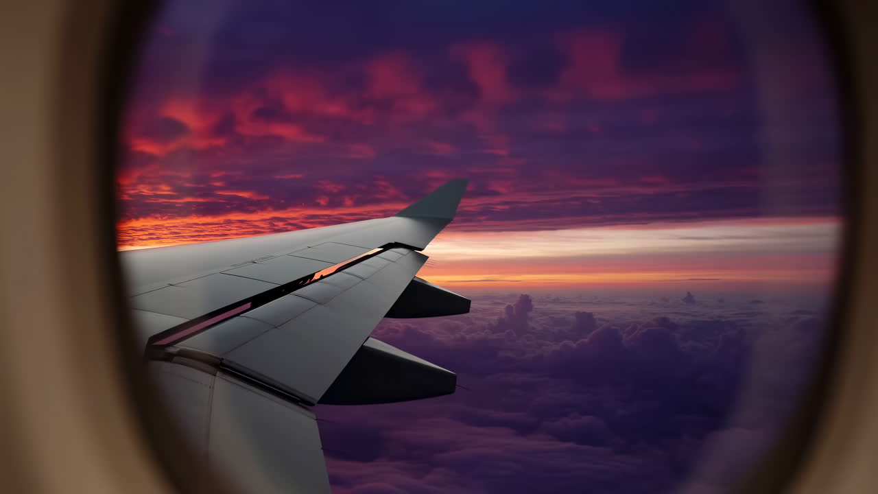Airplane Wing View from Window During Dramatic Sunset Flight
