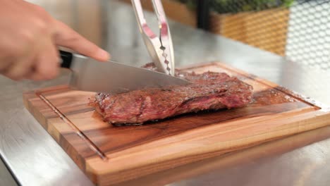 chef cutting hot medium rare flank beef