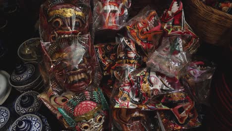 assorted masks and ceramics displayed on table