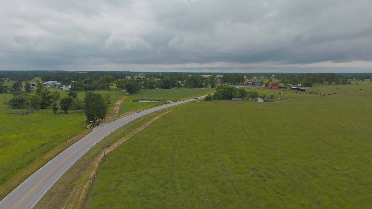 Countryside Road Running Between Green Fields In Cherokee City, Arkansas, USA - Aerial Shot