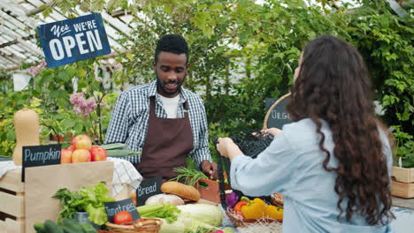 farmer's market transaction in a greenhouse