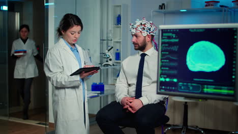 Specialist-doctor-in-neuroscience-taking-notes-on-clipboard