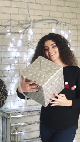 woman with curly hair in a christmas decorated room