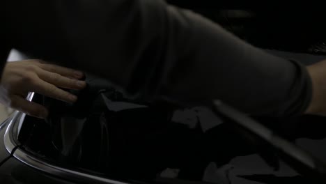 air bubbles being pushed out of window tinting foil on car rear window