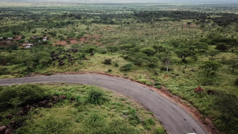 Aerial-view-of-a-white-4x4-car-making-a-driving-trip-in-East-Africa