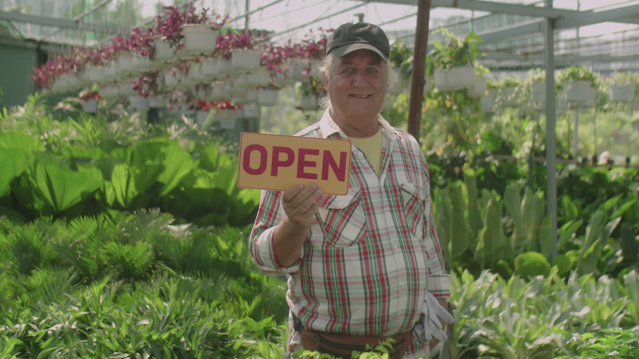 Portrait of Senior Nurseryman with Open Sign