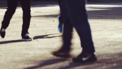 people walking on the street on a sunny day