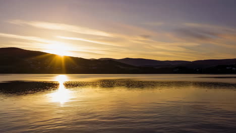 tranquil lake and mountain scenes at sunrise, sunset, and dusk