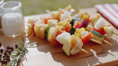 four chicken and vegetable kabobs on cutting board