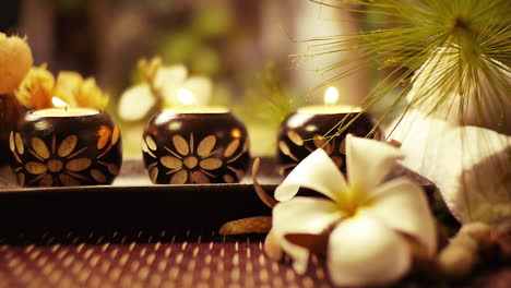 Spa-and-Wellness-Treatment-Decorations-accessories-Inspirations-with-herbal,-sponge-scrub,-aroma-candles,-plumeria-frangipani-flowers,-and-towels,-for-body-and-skin-care-therapy-and-relaxation