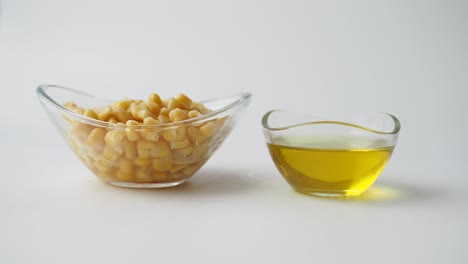 corn kernels and olive oil in glass bowls