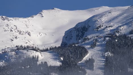 Snow-Covered-Mountain-Tops-on-a-Sunny-Day,-Long-Lens-View,-Static