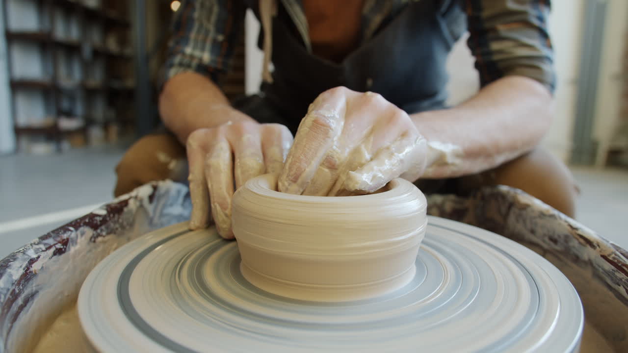 Pottery Artist Shaping Clay on Wheel