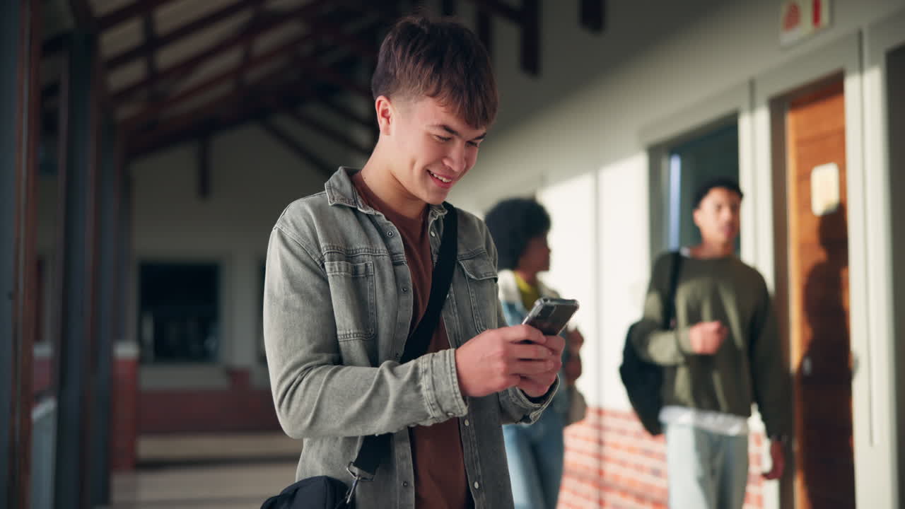 Teenage student using mobile phone in school corridor