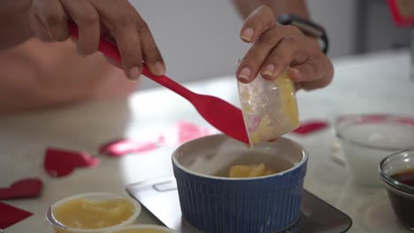 Scooping-out-apple-sauce-from-a-container-into-a-bowl-making-a-special-valentine's-day-cake-vegan-chocolate-cake-eggless-plant-based-dairy-free