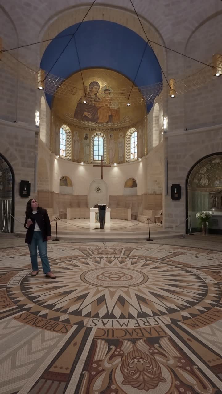 Tourist admiring the mosaic floor inside Dormition Abbey in Jerusalem. Slow motion.