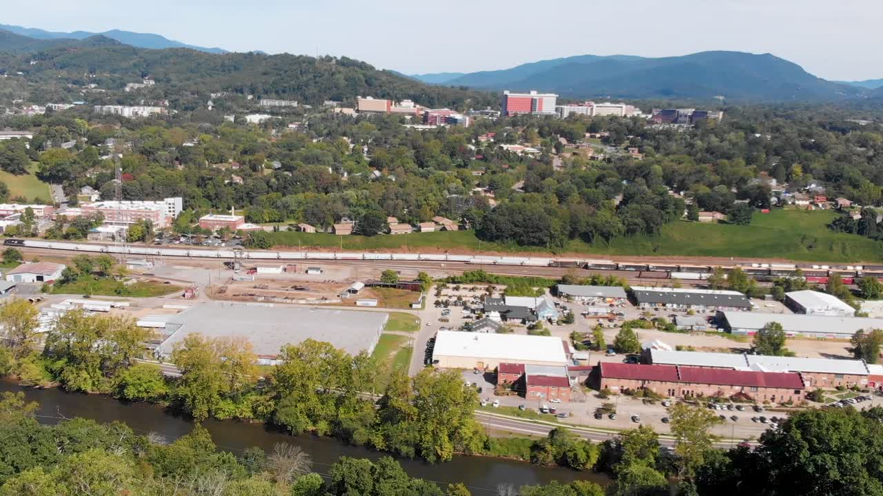 4K Aerial Drone Video of Norfolk Southern Train Yard and River Arts District along the French Broad River in Asheville, NC