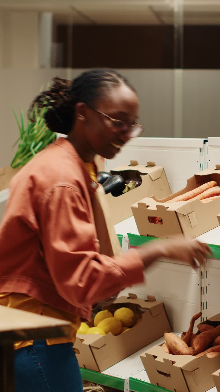 Vertical Video Vegan person searching for freshly harvested vegetables from crates