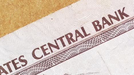 macro pan revealing united arab emirates central bank text on a dirham note