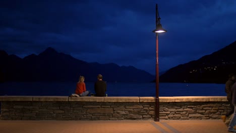 young couple sat on wall