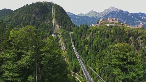 spectacular aerial view of the suspension bridge leading to ehrenberg castle in tyrol, austria