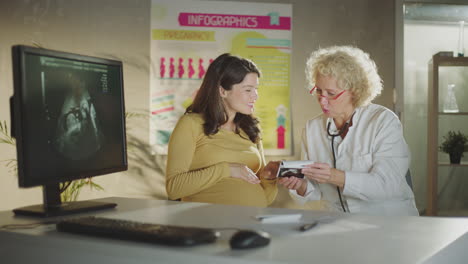 pregnant woman discussing ultrasound with doctor