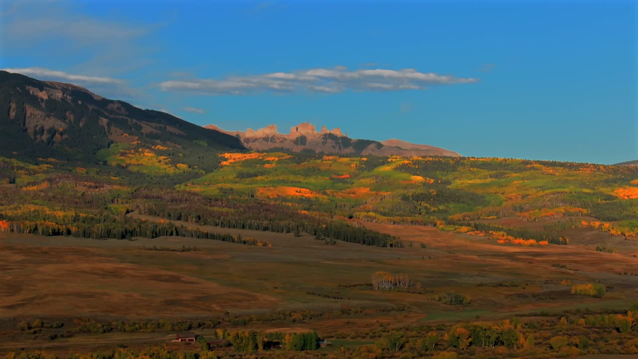 Scenic Fall autumn drive Mill Creek Ranch farm land Ohio Creek Valley Pass near Crested Butte Colorado Gunnison Country aerial drone Mill Castle rock landmark feature colorful Aspen trees upwards