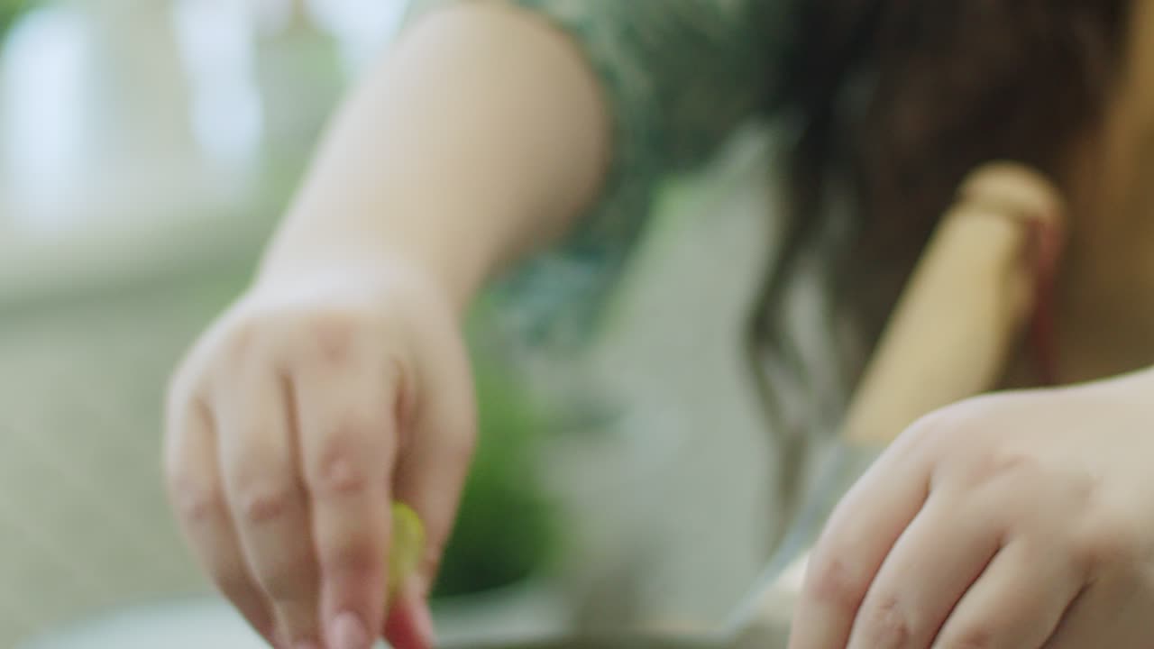 Woman squeezing lime in pan with noodles