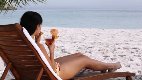 brunette drinking a cocktail