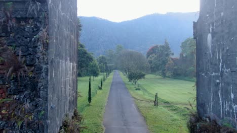 Majestic-landscape-of-Bali-and-gate-of-Handara,-flying-backward-and-through