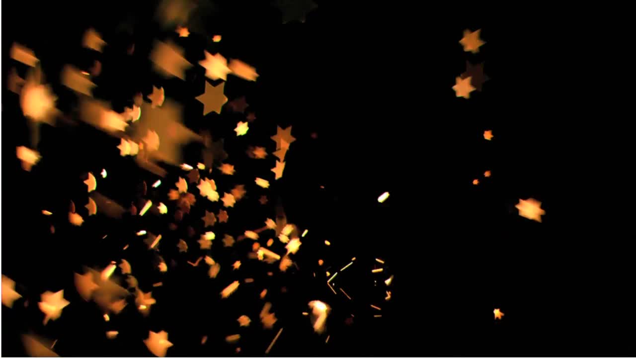 estrellas anaranjadas moviéndose contra un fondo negro