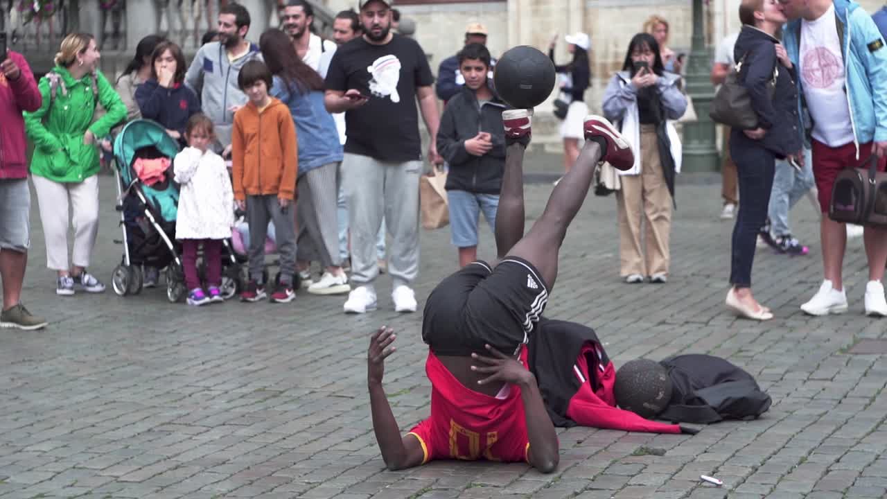 Man playing ball games in Grand Place in Brussels
