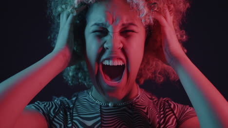 Woman expressing anger and frustration in neon light