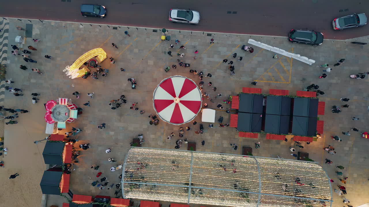 Market crowd evening celebration on festival square top view. Festive lights