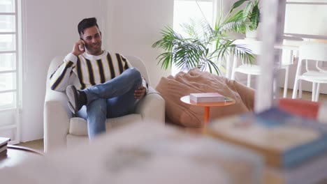 Mixed-race-man-phoning-in-creative-office