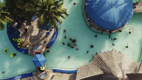 people having fun in the swimming pool of the water park in summer