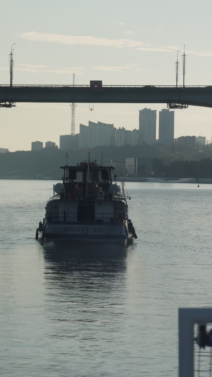 Boat on the River with Bridge and Cityscape