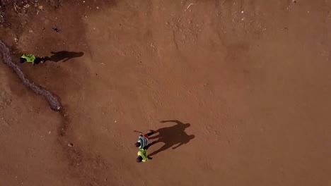 Aerial-looking-straight-down-at-children-playing-soccer-in-the-vast-overpopulated-slum-of-Kibera-Nairobia-Kenya-Africa