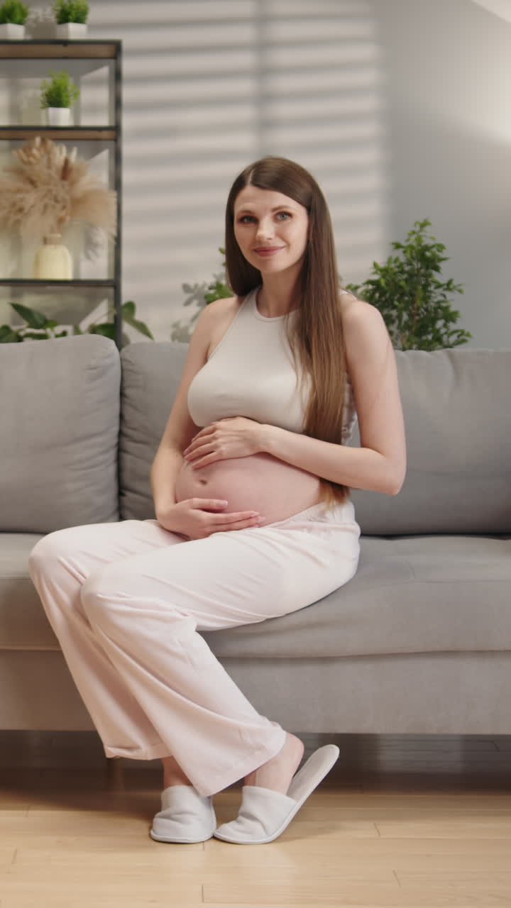 Young woman focused on laptop screen while sitting at table in cozy cafe enjoying coffee and working