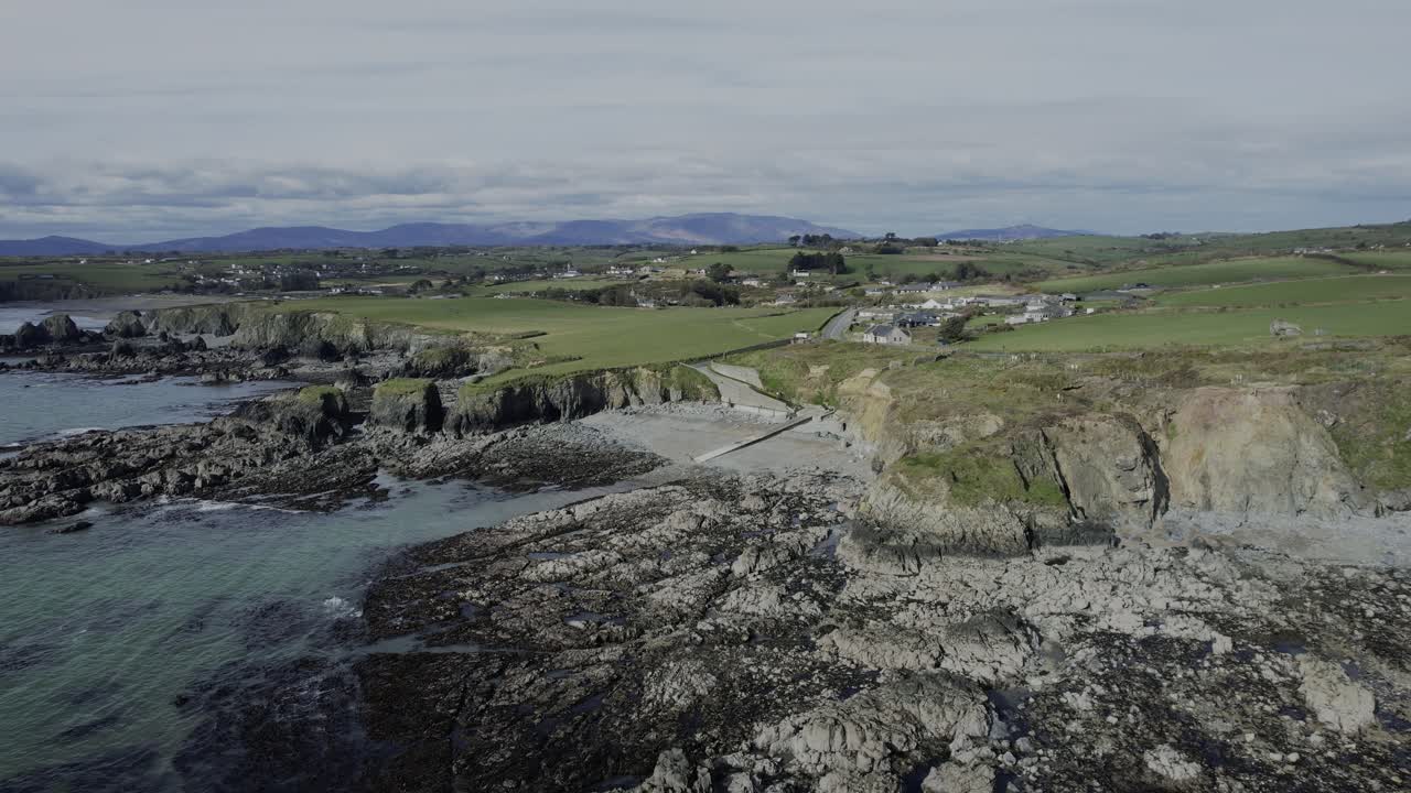 drone rocky beach with mountains in background copper coast Waterford Ireland spring morning