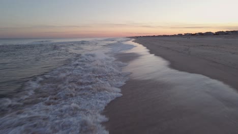 Waves-Crashing-In-Sand-And-A-Beautiful-Afternoon-Sunset---Aerial-moving-medium-shot