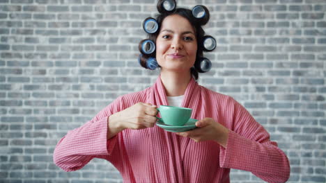 woman enjoying coffee in her bathrobe