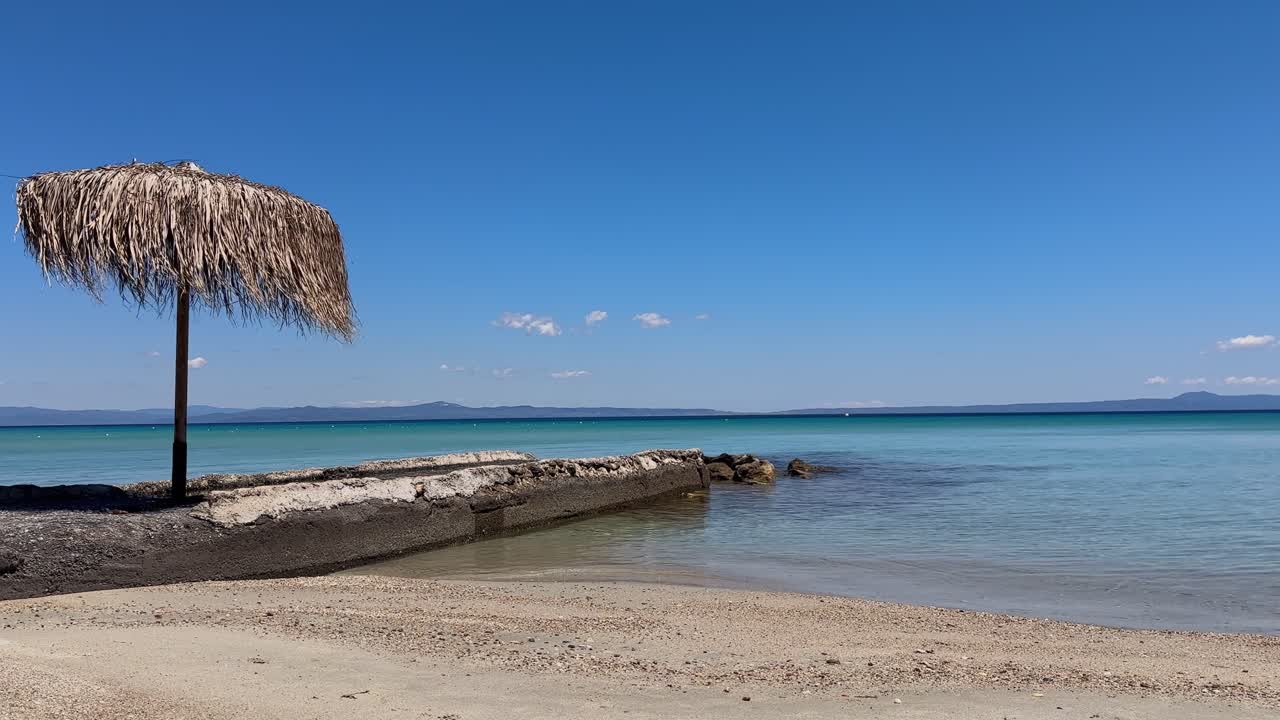 Stunning beach scene in Halkidiki, Greece, with elegant sunbeds facing the crystal-clear turquoise sea. A perfect summer escape in the heart of the Aegean.