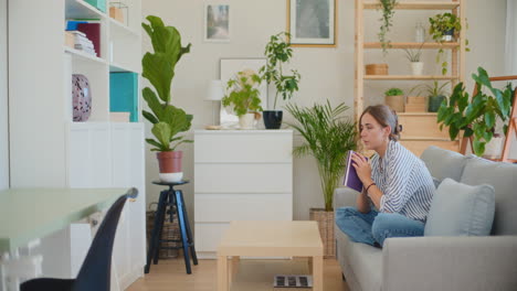 contemplative woman with book generating ideas on sofa