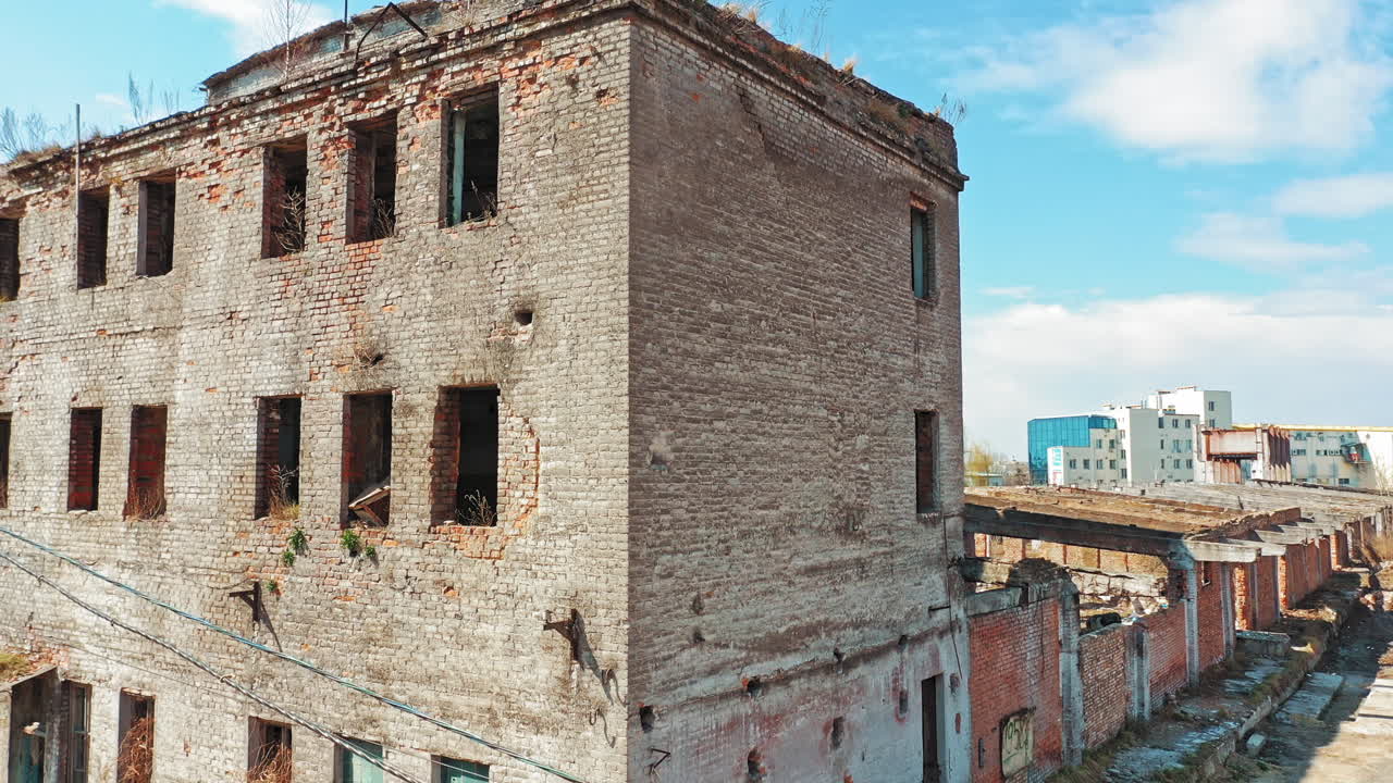 Ruined building without windows and roof outside. Exterior of a broken-down building in the desolate part of the city.