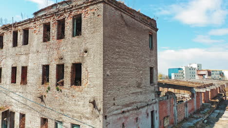 ruined building without windows and roof outside. exterior of a broken-down building in the desolate part of the city.